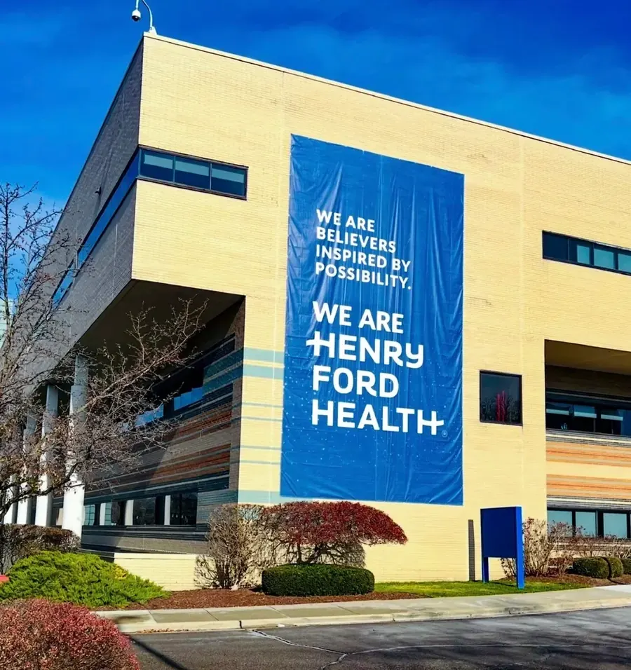 Henry Ford Health building with large banner