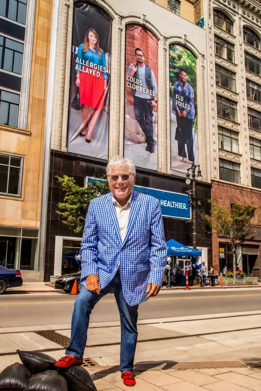 Smiling man in blue blazer on city street